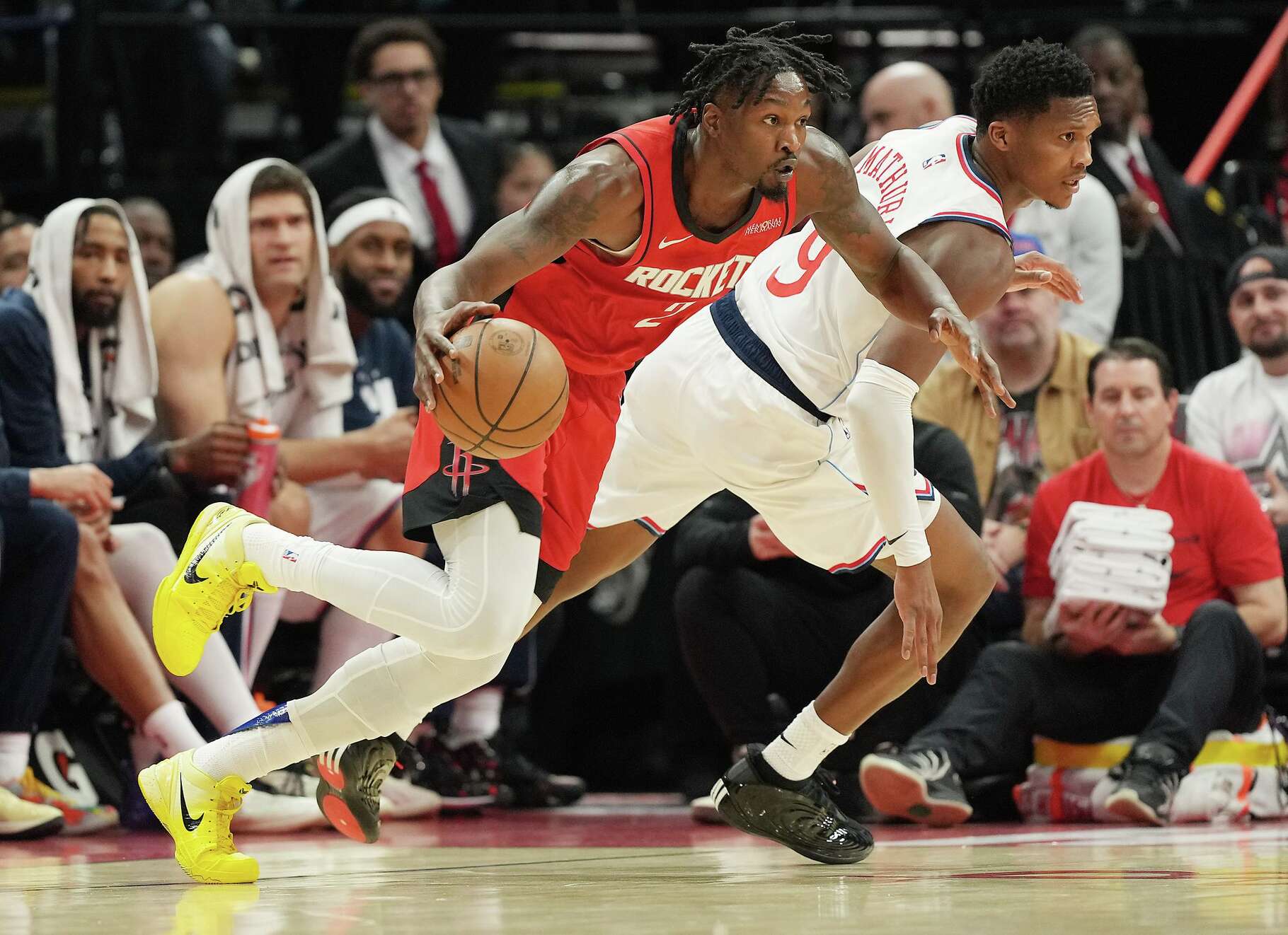 Houston Rockets forward Dorian Finney-Smith (2) drives the ball past LA Clippers Bennedict Mathurin (9) at the Toyota Center in Houston on Tuesday, Feb. 10, 2026.