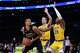 San Antonio Spurs forward Victor Wembanyama (1) is double-teamed by Los Angeles Lakers forward Rui Hachimura (28) and guard Luke Kennard (10) during the first half of an NBA basketball game Tuesday, Feb. 10, 2026, in Los Angeles. (AP Photo/Jae C. Hong)