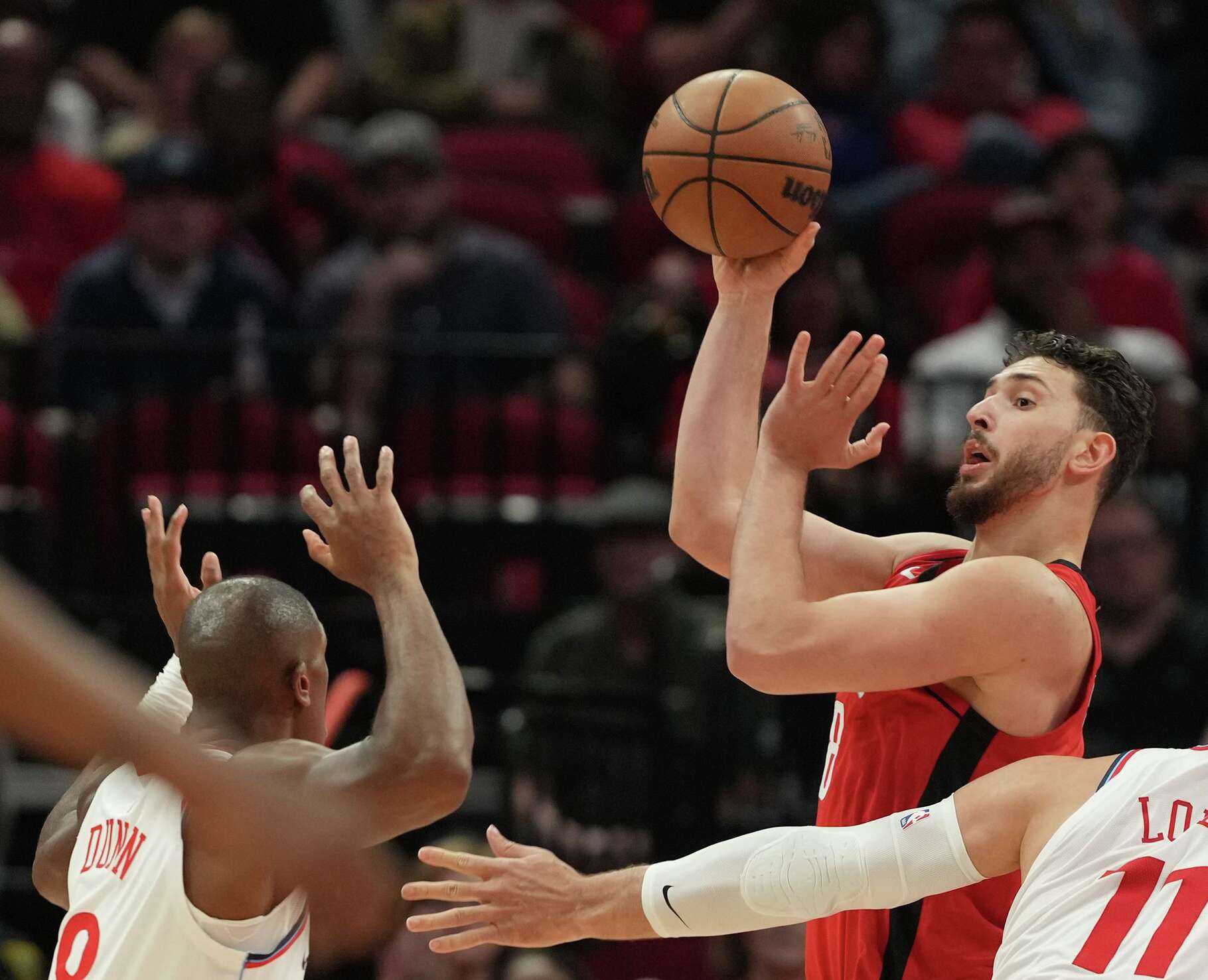 Houston Rockets center Alperen Sengun (28) looks for a teammate to pass too against LA Clippers defense at the Toyota Center in Houston on Wednesday, Feb. 11, 2026.