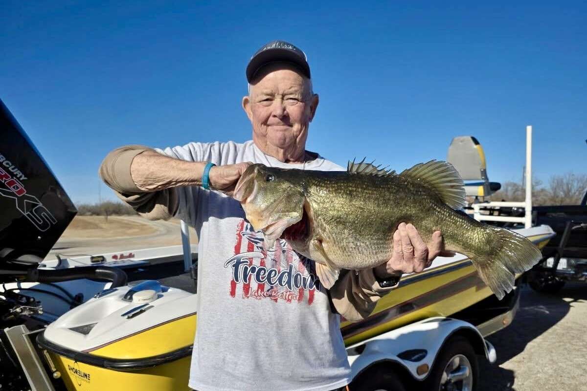 Travis J. McCullough with the 14.35-pound lake-record bass he caught at Fort phantom Hill Lake. 