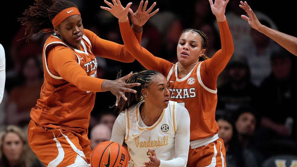 Texas center Kyla Oldacre, left, and Texas guard Jordan Lee, right, defend Vanderbilt guard Mikayla Blakes, center, during the first half of an NCAA college basketball game Thursday, Feb. 12, 2026, in Nashville, Tenn. (AP Photo/George Walker IV)