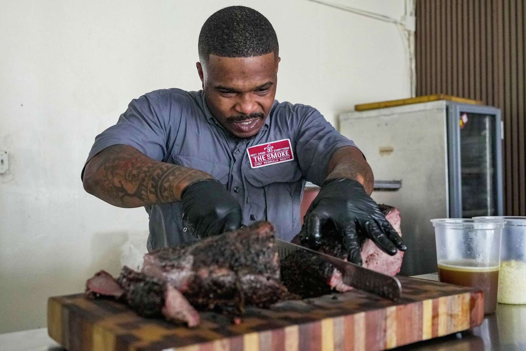 Chef and pit master Reginald Scott of Coarse Restaurant slices brisket at the restaurant in Houston, Friday, Feb. 13, 2026.