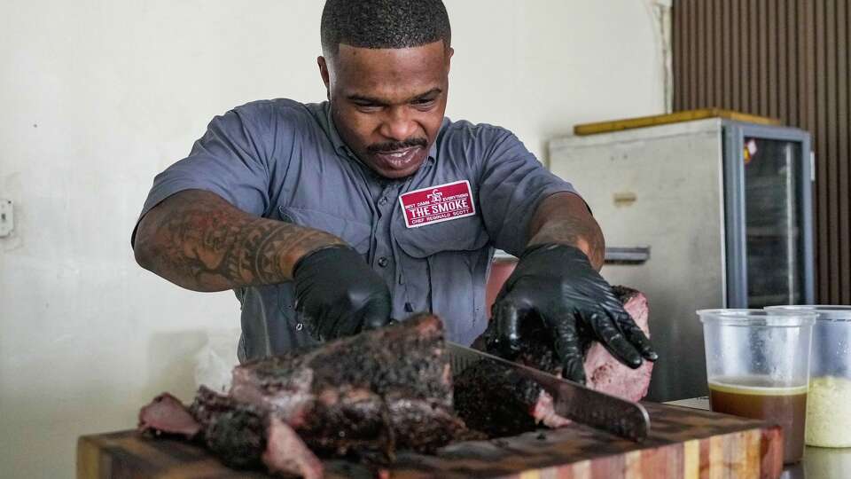 Chef and pit master Reginald Scott of Coarse Restaurant slices brisket at the restaurant in Houston, Friday, Feb. 13, 2026.