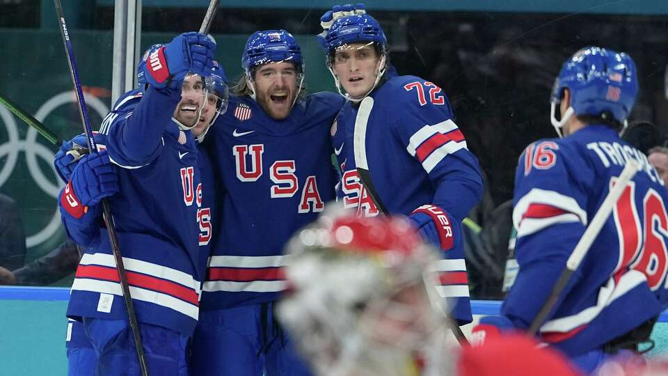 United States' Noah Hanifin, center, celebrates after scoring his side's fourth goal during a preliminary round game of men's ice hockey between the United States and Denmark at the 2026 Winter Olympics, in Milan, Italy, Saturday, Feb. 14, 2026. (AP Photo/Petr David Josek)