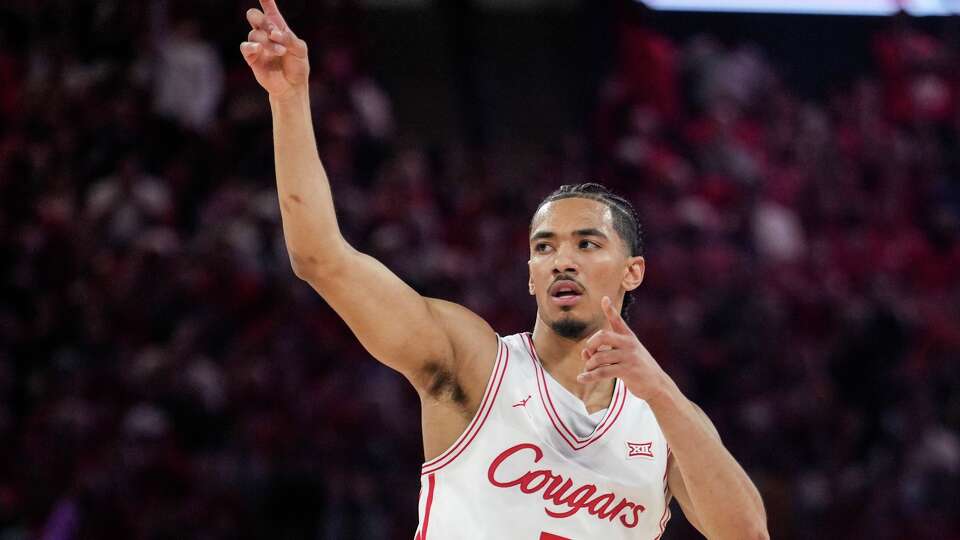 Houston guard Milos Uzan (7) reacts after hitting a 3-pointer against Kansas State during the first half of an NCAA college basketball game at Fertitta Center in Houston, Saturday, Feb. 14, 2026.