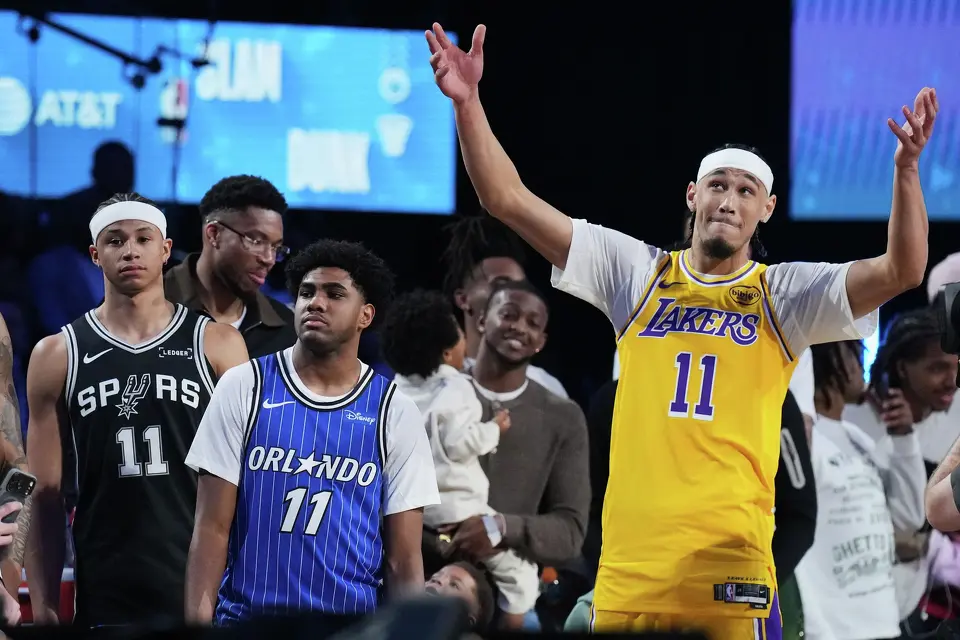 Los Angeles Lakers center Jaxson Hayes, right, reacts after dunking next to Orland Magic guard Jase Richardson and San Antonio Spurs forward Carter Bryant during the slam dunk contest at the NBA basketball All-Star weekend festivities Saturday, Feb. 14, 2026, in Inglewood, Calif. (AP Photo/Mark J. Terrill)