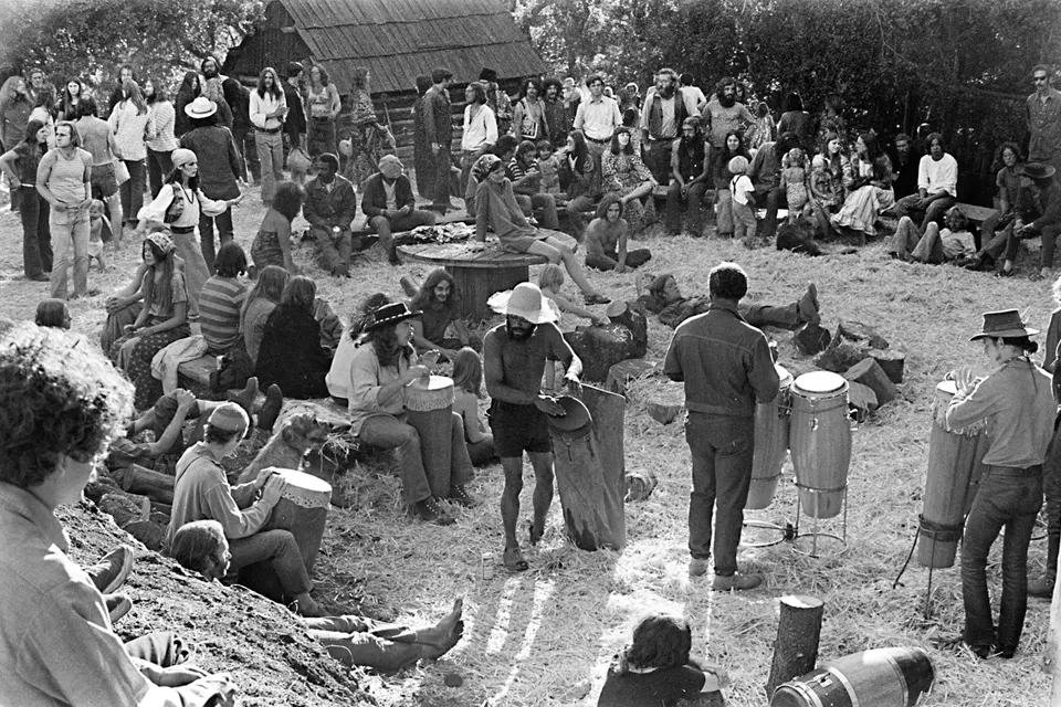 A drum circle forms at the 1973 Big Sur Harvest Party.