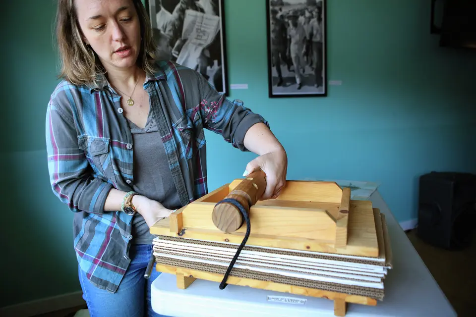 Laura Klein, a plant biologist at LeafWorks, shows a leaf pressing at a meeting in Santa Cruz for the state’s appellation program. Klein is the director of a herbarium that is collecting cannabis plants in order to document and preserve the cannabis plant history.