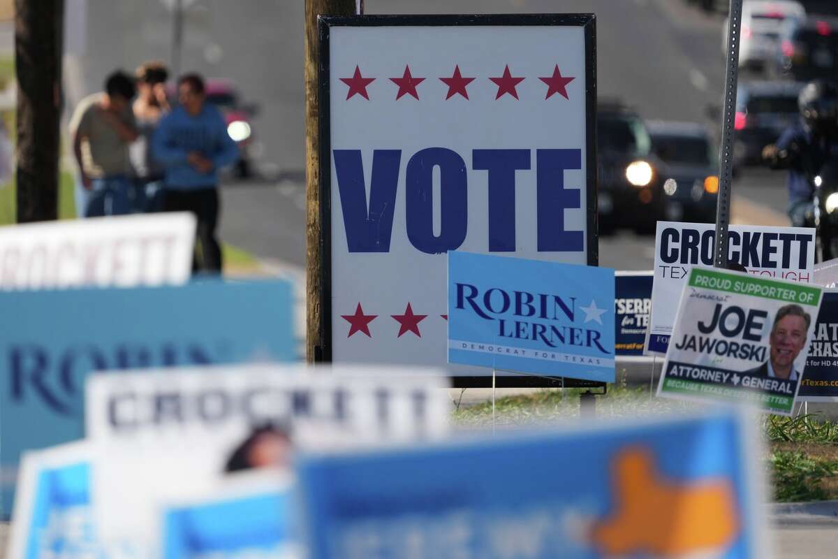 Election signs crowd an intersection near a polling place, in Austin, Texas, Tuesday, Feb. 17, 2026.