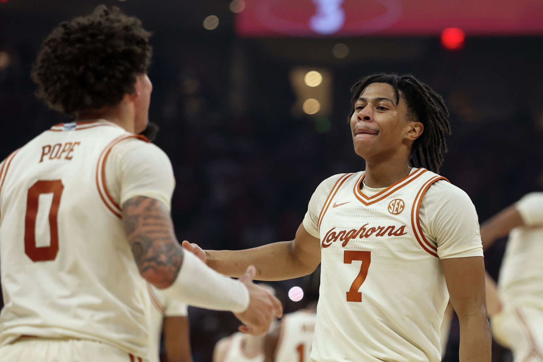 Texas guards Simeon Wilcher (7) and Jordan Pope (0) celebrate a win over LSU on Tuesday.
