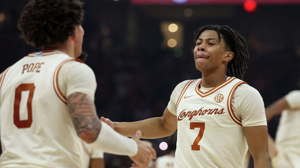 Texas guards Simeon Wilcher (7) and Jordan Pope (0) celebrate a win over LSU on Tuesday.