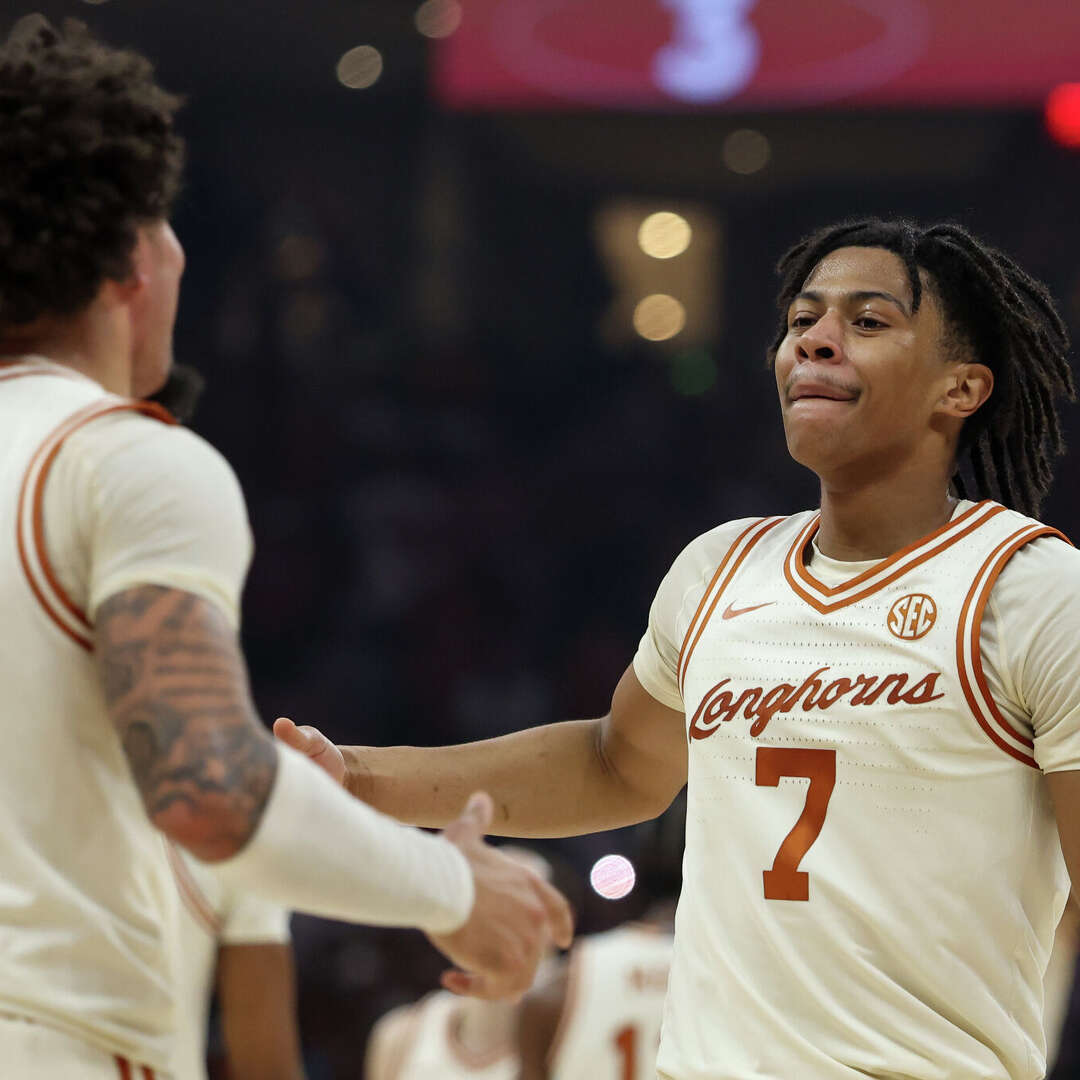 Texas guards Simeon Wilcher (7) and Jordan Pope (0) celebrate a win over LSU on Tuesday.