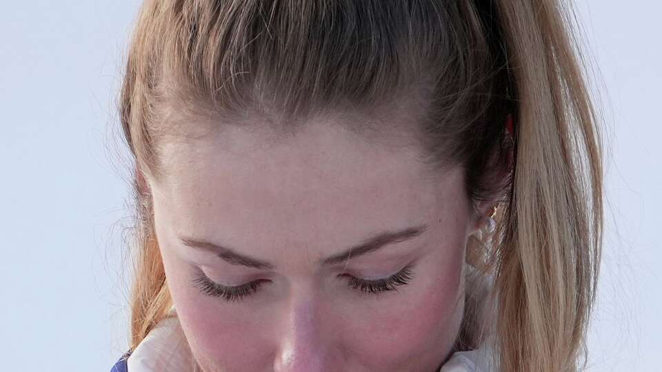 United States' Mikaela Shiffrin looks at her gold medal in an alpine ski, women's slalom race, at the 2026 Winter Olympics, in Cortina d'Ampezzo, Italy, Wednesday, Feb. 18, 2026.