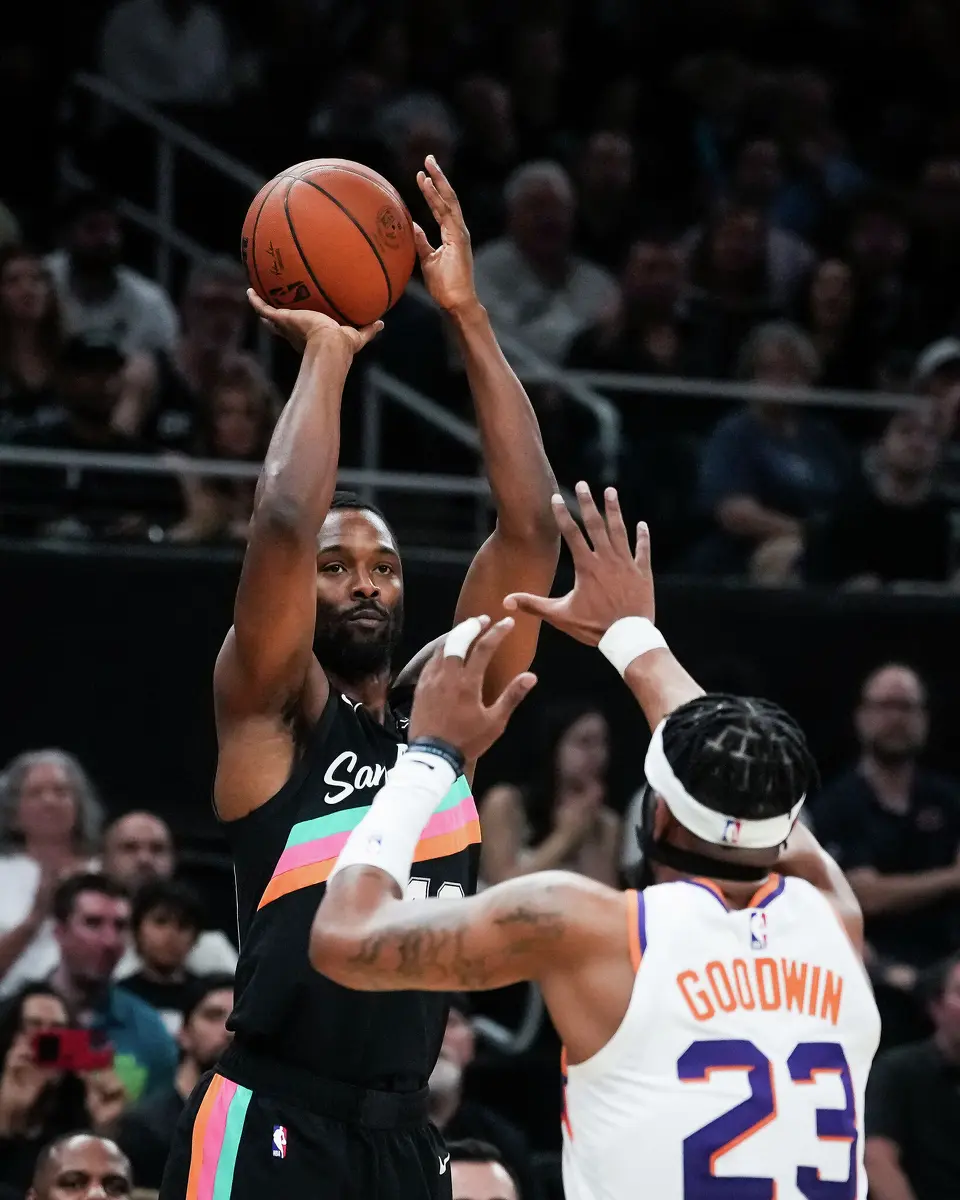 San Antonio Spurs forward Harrison Barnes (40) shoots for three over Phoenix Suns guard Jordan Goodwin (23) in the first quarter as the Spurs take on the Suns on Thursday night, Feb. 19, 2026 in the first of two “I-35 Series” games in Austin at the Moody Center.