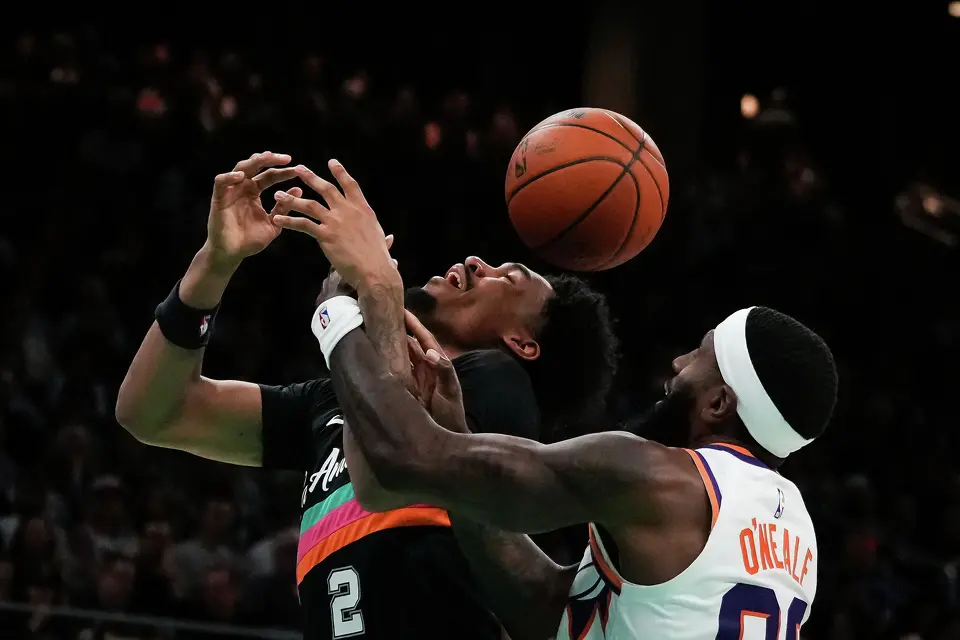Phoenix Suns forward Royce O'Neale (00) fouls San Antonio Spurs guard Dylan Harper (2) in the second quarter as the Spurs take on the Suns on Thursday night, Feb. 19, 2026 in the first of two “I-35 Series” games in Austin at the Moody Center.