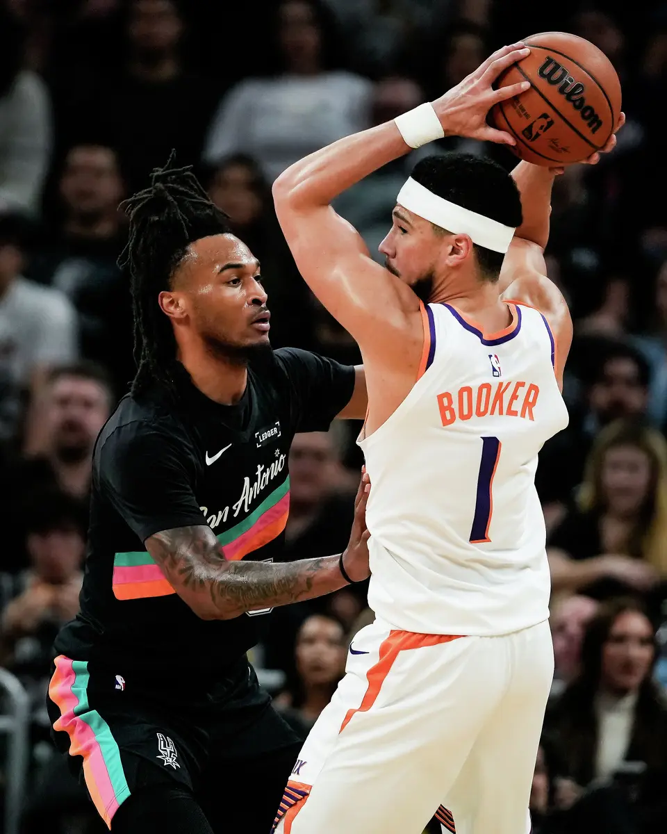 San Antonio Spurs guard Stephon Castle (5) defends against Phoenix Suns guard Devin Booker (1) in the first quarter as the Spurs take on the Suns on Thursday night, Feb. 19, 2026 in the first of two “I-35 Series” games in Austin at the Moody Center.