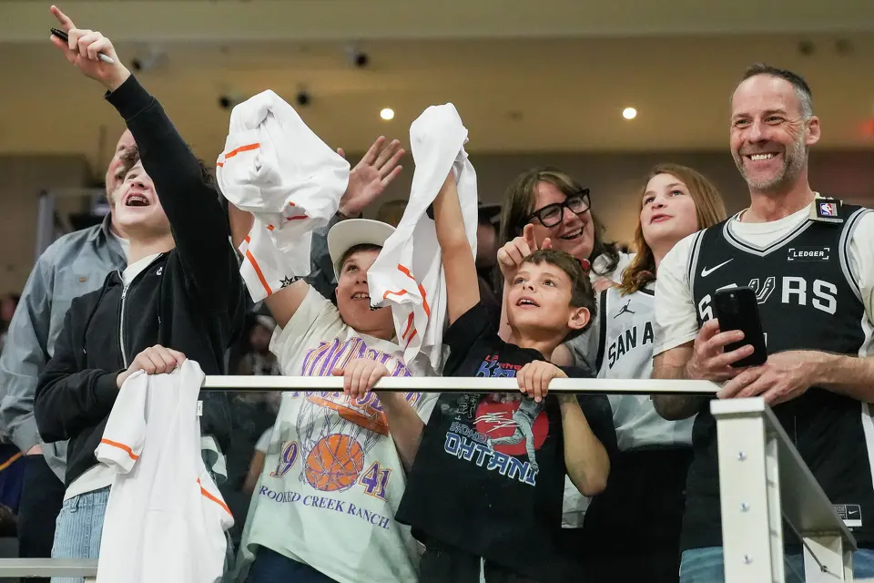 Fans celebrate being featured on the jumbotron ahead of the Spurs’ game against the Suns on Thursday night, Feb. 19, 2026 in the first of two “I-35 Series” games in Austin at the Moody Center. The Spurs won the game 121-94.