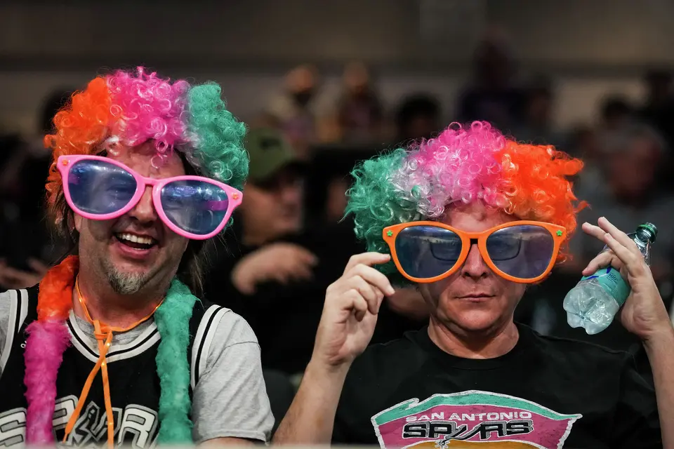 San Antonio Spurs fans wear colorful wigs ahead the Spurs’ game against the Suns on Thursday night, Feb. 19, 2026 in the first of two “I-35 Series” games in Austin at the Moody Center.