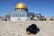 A man prays near the Dome of the Rock shrine at the Aqsa mosque compound in the old city of Jerusalem on the first Friday of the Muslim holy month of Ramadan on February 20, 2026. (Photo by Ahmad GHARABLI / AFP via Getty Images)