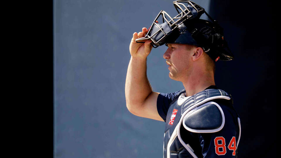 Houston Astros catcher Walker Janek (84) walks pass batting cages during Spring Training at CACTI Park of the Palm Beaches in West Palm Beach, Tuesday, Feb. 17, 2026.