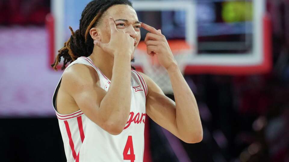 Houston guard Kingston Flemings (4) motions toward forward Kalifa Sakho after missing a wide-open shot during the second half of an NCAA college basketball game in Houston, Saturday, Feb. 21, 2026.