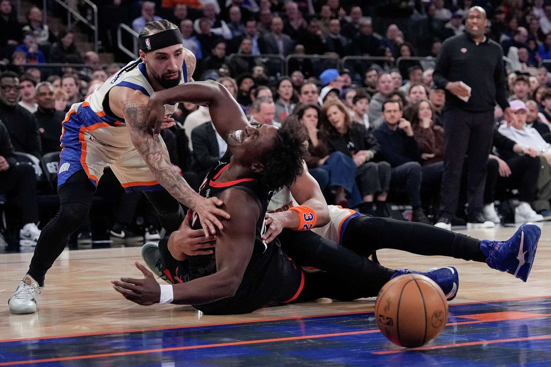 Houston Rockets forward Jae'sean Tate (8) fights for control of the ball with New York Knicks guard Jose Alvarado (5) and New York Knicks center Karl-Anthony Towns during the first half of an NBA basketball game, Saturday, Feb. 21, 2026, in New York. (AP Photo/Yuki Iwamura)