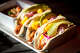 Avocado slices and pineapple chunks top the Al Pastor Tacos at Beto and Son restaurant in Trinity Groves.