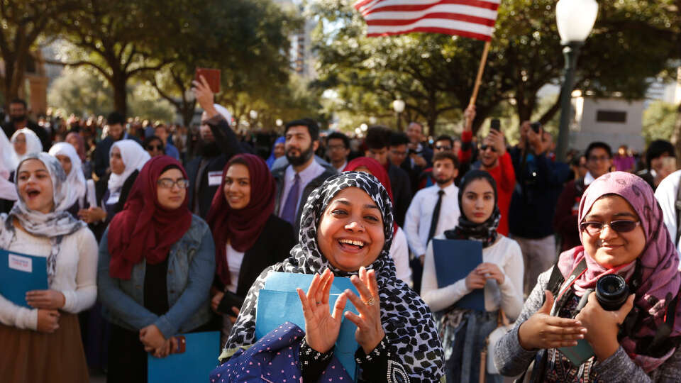 Naheda Khan and daughter Meherina Khan, 18 of Houston clap as they cheer for America during a press conference at the steps of the Texas Capitol during the Texas Muslim Capitol Day rally in Austin on Tuesday, January 31, 2017.