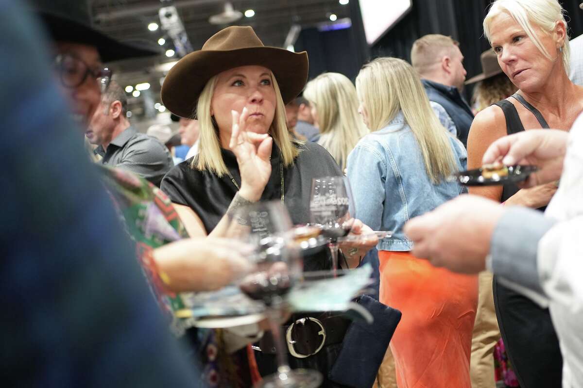An attendee gives her approval for Cotton Culinary's offerring during the 2026 Rodeo Uncorked! Roundup & Best Bites Competition at NRG Center in Houston on Sunday, Feb. 22, 2026.