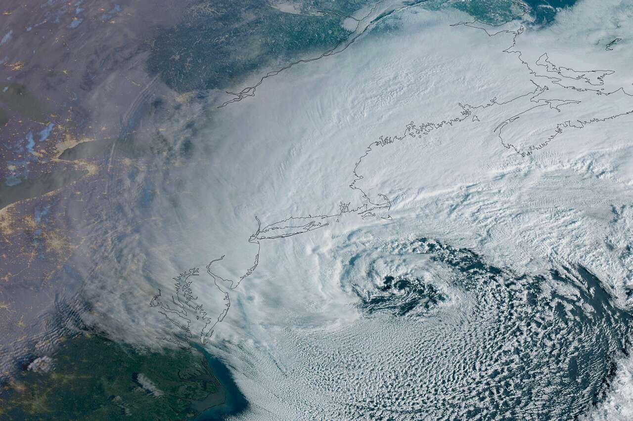 A major winter storm, seen here in a weather satellite photo taken just after sunrise Monday, bears down on New England and the northeastern United States, triggering blizzard and winter storm warnings along the Eastern Seaboard, from Washington, D.C., to Boston.