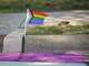A Pride flag is displayed next to a rainbow crosswalk on Morrow Street in the Crestview neighborhood of Austin on Monday, Feb. 23, 2026. The crosswalk was repainted over the weekend by a group of neighbors using what one resident described as chalk-based, nonpermanent paint after the city removed several decorated crosswalks last week citing pressure from the federal government. Some neighbors also added rainbow paint to their driveways and walkways, and an area church displayed a sign supporting the crosswalks.