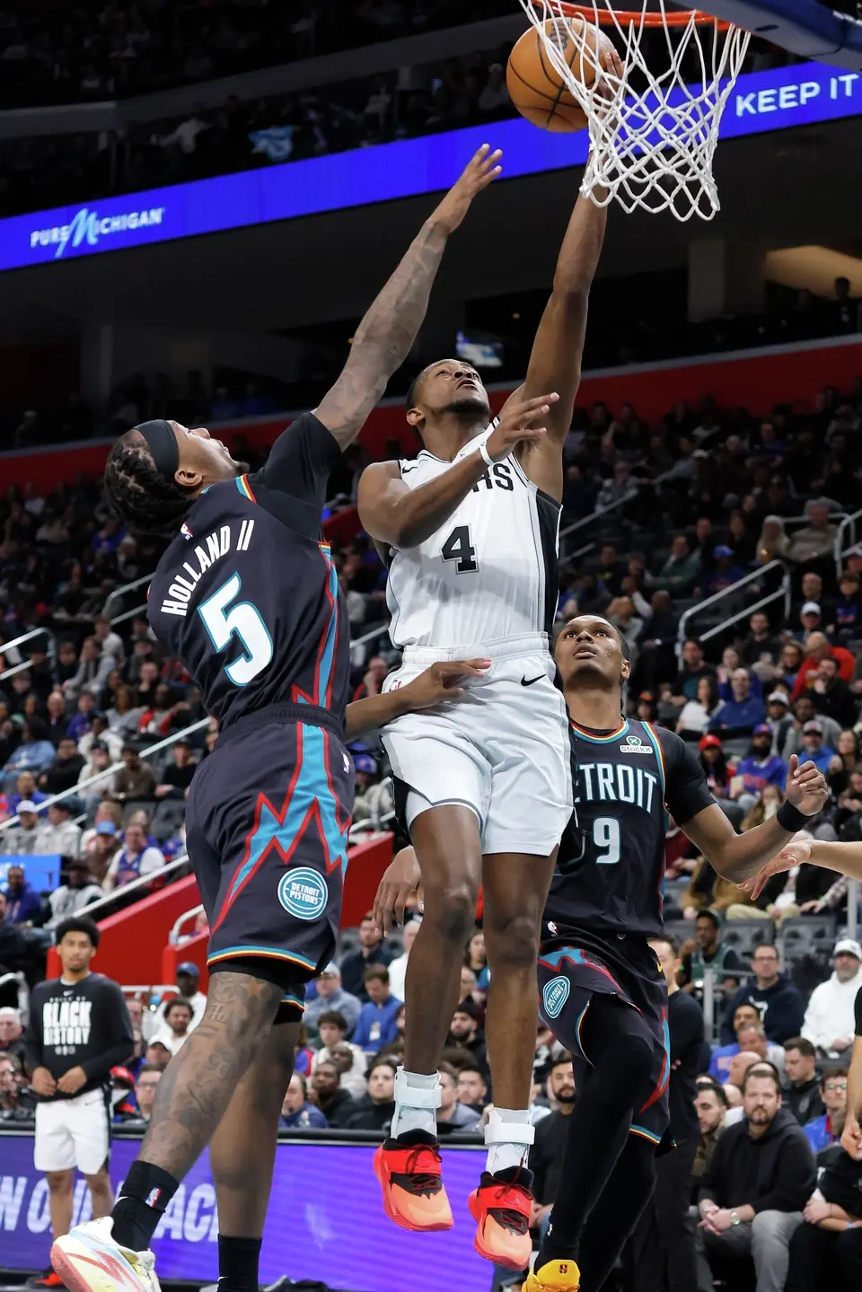 San Antonio Spurs guard De'aaron Fox (4) goes to the basket against Detroit Pistons forward Ronald Holland II (5) during the first half of an NBA basketball game Monday, Feb. 23, 2026, in Detroit. (AP Photo/Duane Burleson)