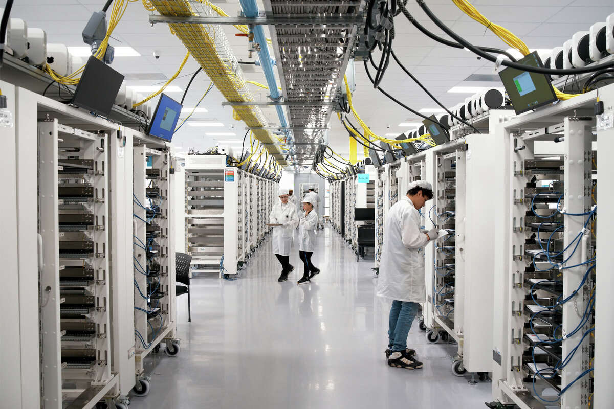 In Houston, workers assemble advanced AI servers, including logic boards produced onsite, which are then used in Apple data centers in the U.S.