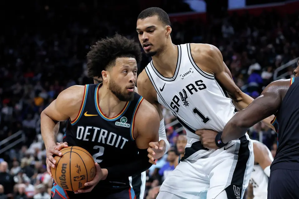 Detroit Pistons guard Cade Cunningham (2) drives against San Antonio Spurs forward Victor Wembanyama (1) during the second half of an NBA basketball game Monday, Feb. 23, 2026, in Detroit. (AP Photo/Duane Burleson)