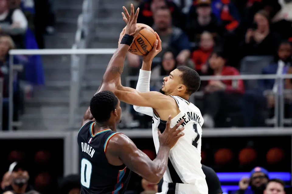 San Antonio Spurs forward Victor Wembanyama (1) takes a shot against Detroit Pistons center Jalen Duren (0) during the second half of an NBA basketball game Monday, Feb. 23, 2026, in Detroit. (AP Photo/Duane Burleson)
