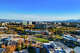 An aerial view of the main business district in Santa Clara, Calif., with Mission College in the foreground and the mountains of the Santa Clara Valley in the background.