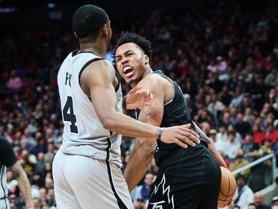 Toronto Raptors' Scottie Barnes, right, reacts after stealing the ball from San Antonio Spurs' De'Aaron Fox (4) during the second half of an NBA basketball game in Toronto, on Wednesday, Feb. 25, 2026. (Sammy Kogan/The Canadian Press via AP)