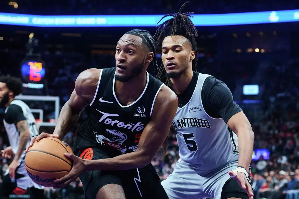 Toronto Raptors' Immanuel Quickley (5) drives past San Antonio Spurs' Stephon Castle (5) during the first half of an NBA basketball gsme in Toronto, on Wednesday, Feb. 25, 2026. (Sammy Kogan/The Canadian Press via AP)