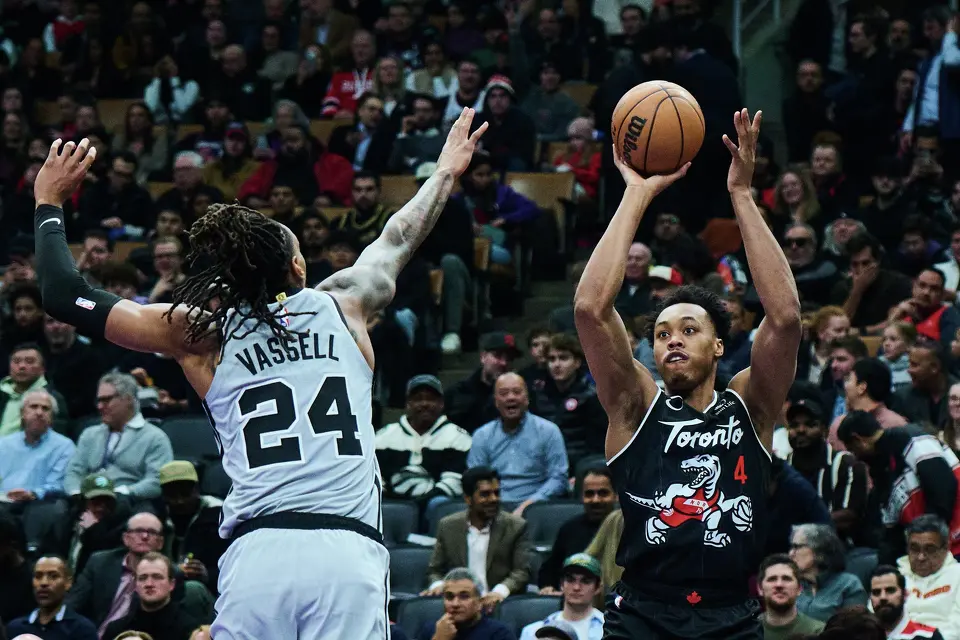 Toronto Raptors' Scottie Barnes (4) shoots past San Antonio Spurs' Devin Vassell (24) during the first half of an NBA basketball game in Toronto, Wednesday, Feb. 25, 2026. (Sammy Kogan/The Canadian Press via AP)