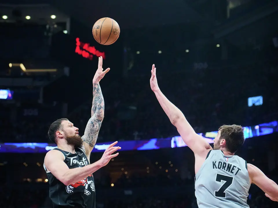 Toronto Raptors' Sandro Mamukelashvili (54) shoots over San Antonio Spurs' Luke Kornet (7) during the first half of an NBA basketball game, in Toronto, Wednesday, Feb. 25, 2026. (Sammy Kogan/The Canadian Press via AP)