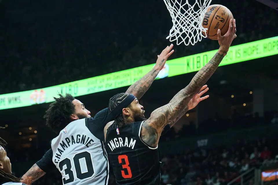Toronto Raptors' Brandon Ingram (3) drives to the net past San Antonio Spurs' Julian Champagnie (30) during the first half of an NBA basketball game in Toronto, Wednesday, Feb. 25, 2026. (Sammy Kogan/The Canadian Press via AP)
