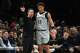 San Antonio Spurs Head Coach Mitch Johnson, left, talks to Carter Bryant (11) during the first half of an NBA basketball game against the Brooklyn Nets Thursday, Feb. 26, 2026, in New York. (AP Photo/Frank Franklin II)