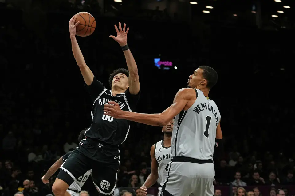 Brooklyn Nets' Nolan Traore, left, drives past San Antonio Spurs' Victor Wembanyama during the first half of an NBA basketball game Thursday, Feb. 26, 2026, in New York. (AP Photo/Frank Franklin II)