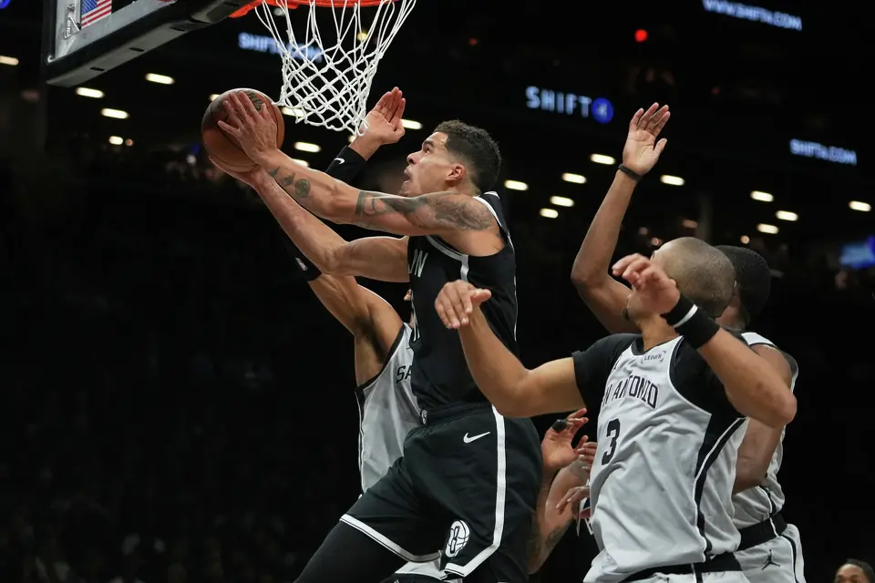 Brooklyn Nets' Michael Porter Jr.drives past San Antonio Spurs' Keldon Johnson, right, during the first half of an NBA basketball game Thursday, Feb. 26, 2026, in New York. (AP Photo/Frank Franklin II)