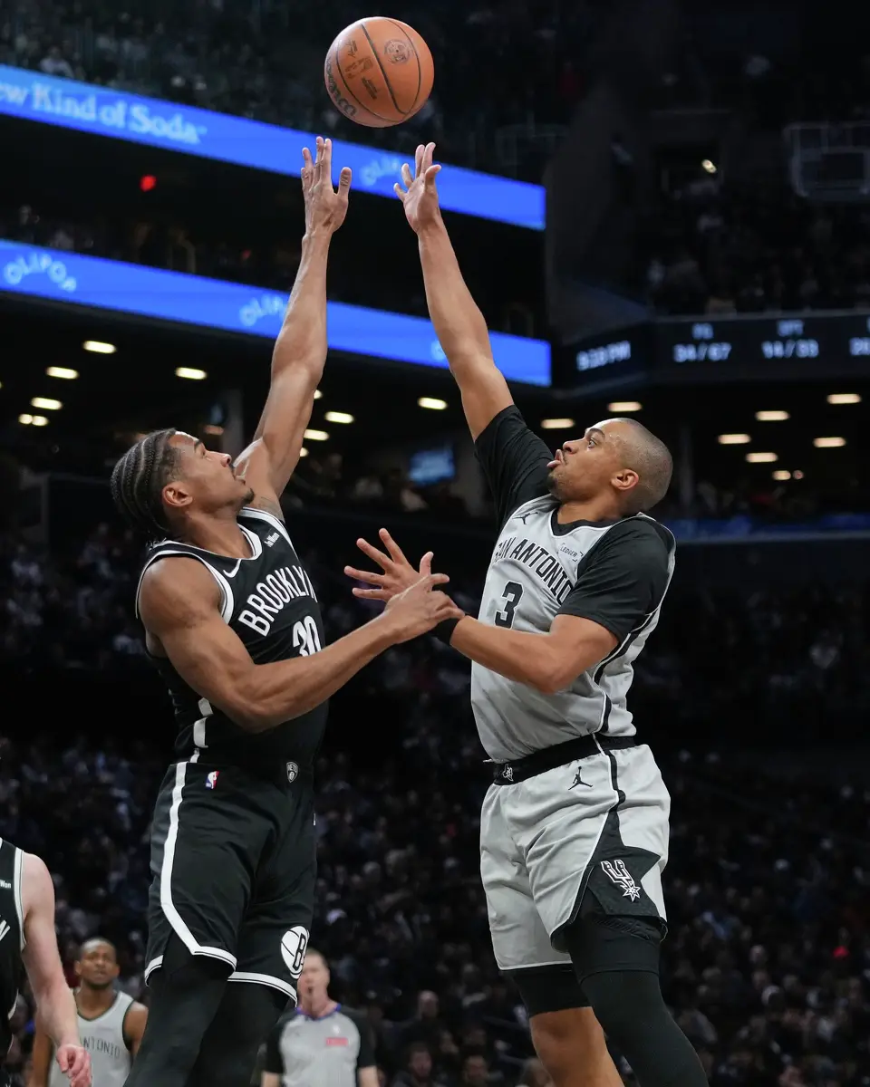 San Antonio Spurs' Keldon Johnson, right, shoots over Brooklyn Nets' Ochai Agbaji during the second half of an NBA basketball game Thursday, Feb. 26, 2026, in New York. (AP Photo/Frank Franklin II)