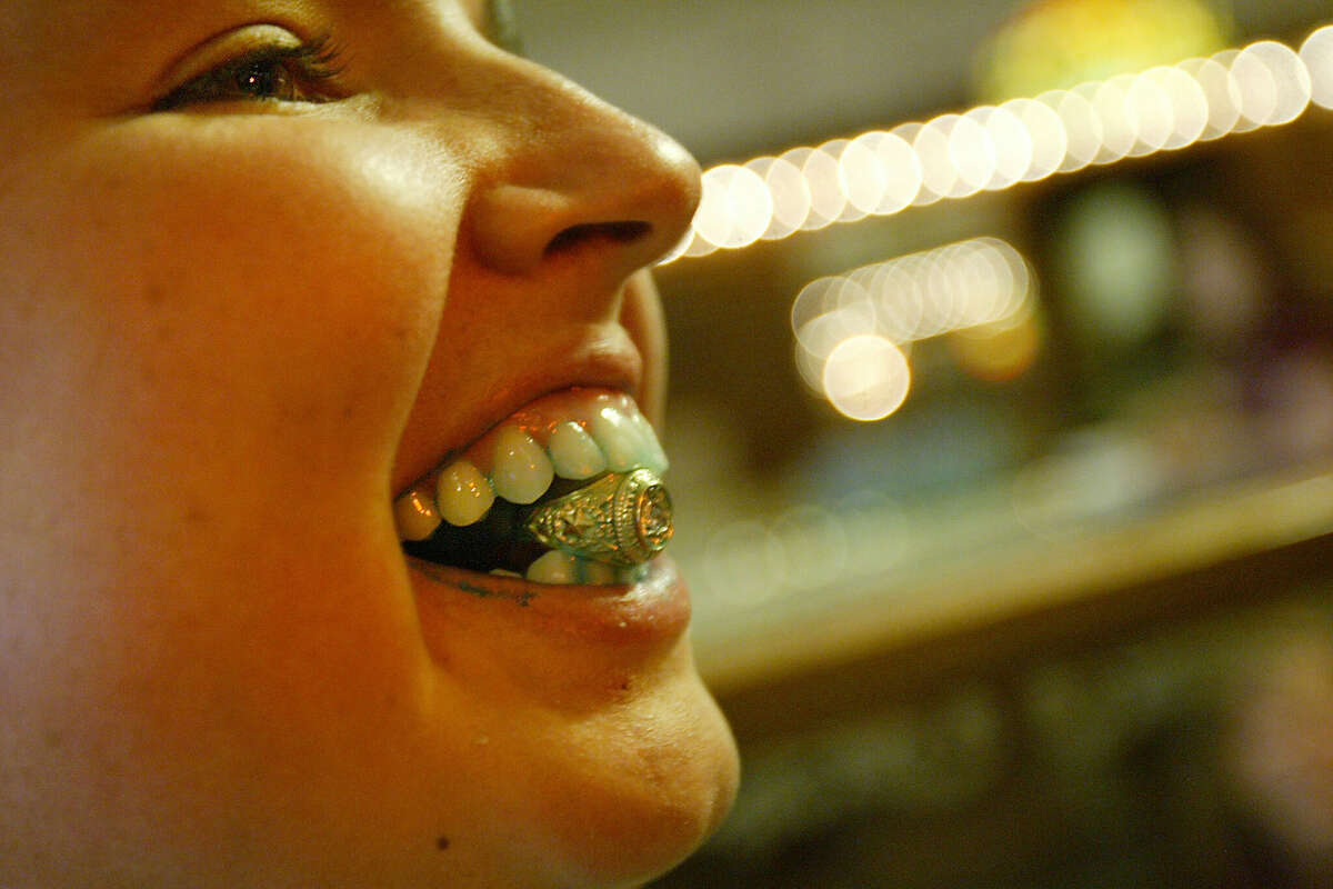 Christy Blankenship, 20, clamps down her Class of 2006 ring to show off to friends after she dunked her in six scoops of 'superhero vanila' ice cream and ate it in almost 2 minutes and six seconds at Swensen's Ice Cream Factory. Texas A&M University distributed approximately 3,500 graduation rings at the Clayton W. Williams, Jr. Alumni Center which is a yearly Aggie tradition.