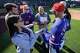 Dallas Morning News sportswriter Evan Grant (center) laughs as writers interview Texas Rangers manager Skip Schumaker on the field after a spring training game against the Kansas City Royals at Surprise Stadium on Friday, Feb. 20, 2026, in Surprise, Ariz.