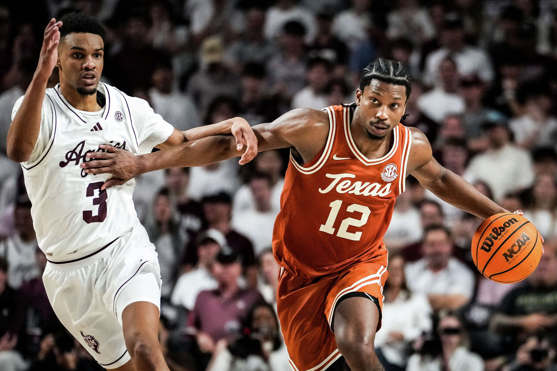 Texas Longhorns guard Tramon Mark (12) dribbles down the court as Texas A&M Aggies guard Rylan Griffen (3) defends in the second half as the Texas Longhorns play the Texas A&M Aggies at Reed Arena in College Station, Feb. 28, 2026. Texas won the game 76-70.