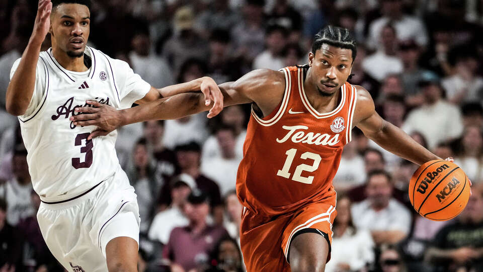 Texas Longhorns guard Tramon Mark (12) dribbles down the court as Texas A&M Aggies guard Rylan Griffen (3) defends in the second half as the Texas Longhorns play the Texas A&M Aggies at Reed Arena in College Station, Feb. 28, 2026. Texas won the game 76-70.
