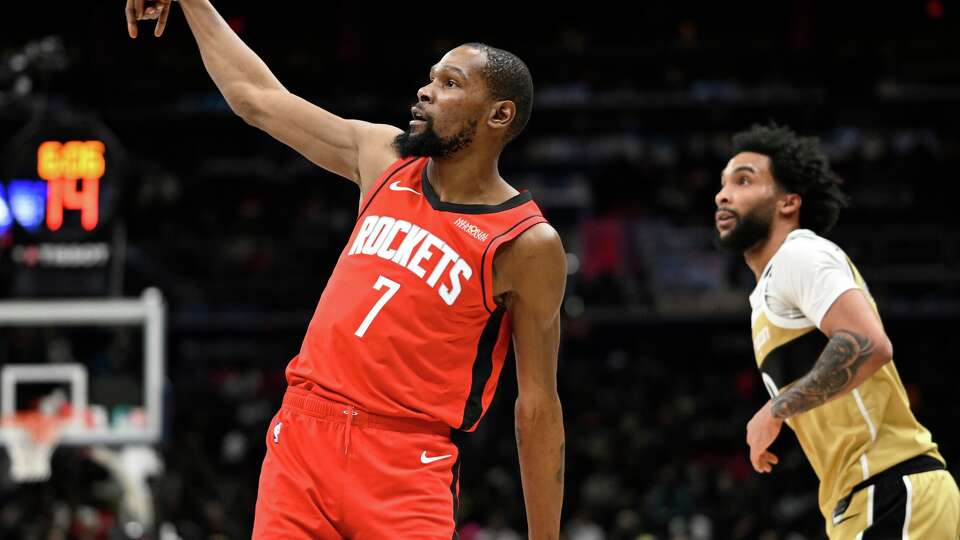 Houston Rockets forward Kevin Durant (7) watches his 3-point shot go in with Washington Wizards forward Justin Champagnie during the first half of an NBA basketball game, Monday, March 2, 2026, in Washington. (AP Photo/John McDonnell)